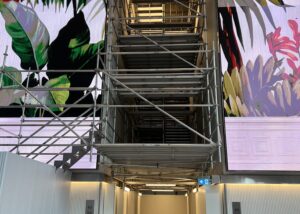 Aluminium scaffolding tower in the lobby of 180 George Street, Sydney, providing ceiling access for defect repairs while maintaining tenant and lobby access.