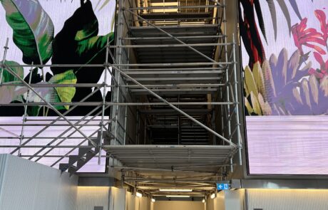 Aluminium scaffolding tower in the lobby of 180 George Street, Sydney, providing ceiling access for defect repairs while maintaining tenant and lobby access.