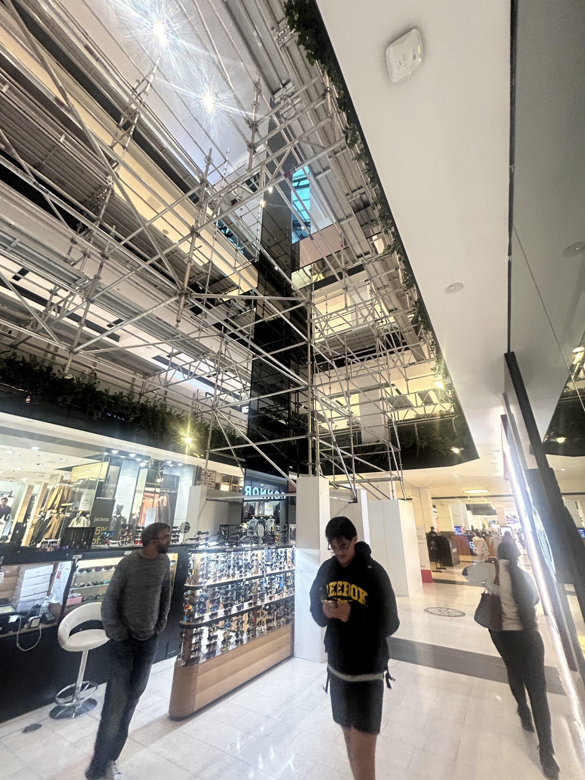 Aluminium Scaffolding in Live Shopping Centre – Westfield Parramatta Shoppers walking freely beneath aluminium scaffolding in live retail environment at Westfield Parramatta Sydney
