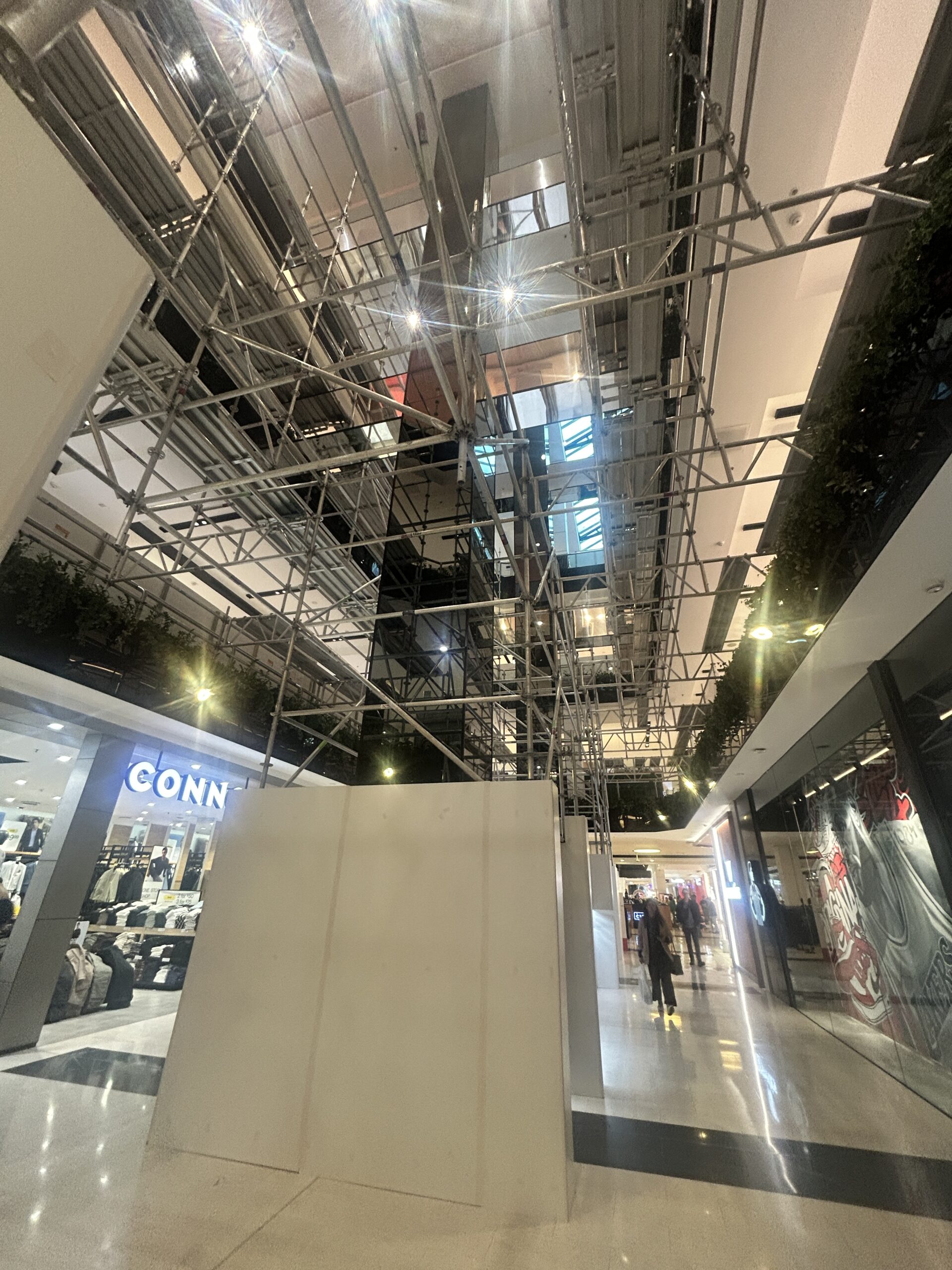 Indoor Aluminium Scaffolding with Hoarding – Westfield Parramatta Indoor aluminium scaffolding with hoarding panels in live retail corridor at Westfield Parramatta Sydney